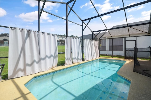 view of swimming pool with glass enclosure