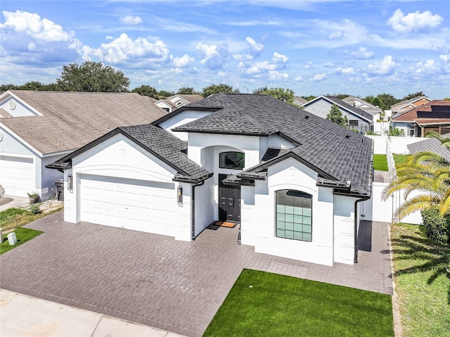 view of front of property featuring a garage and a front lawn