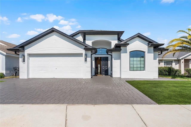 view of front facade with a front yard and a garage