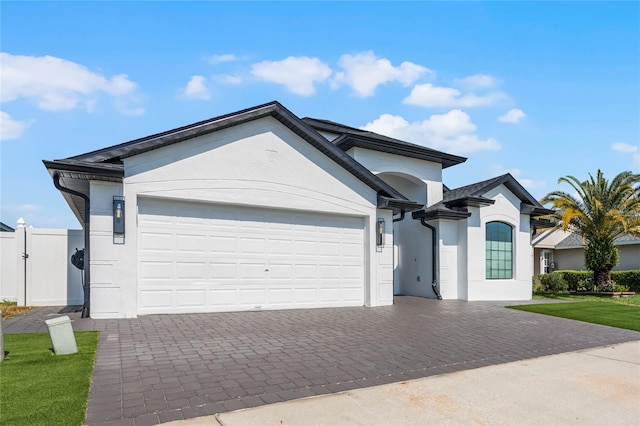 view of front of property featuring a front lawn and a garage