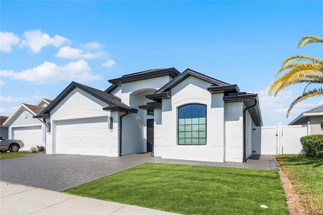 view of front of house with a garage and a front yard