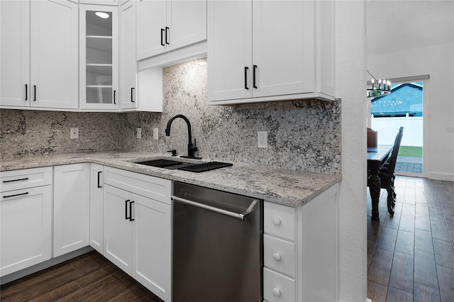 kitchen featuring decorative backsplash, white cabinetry, and sink