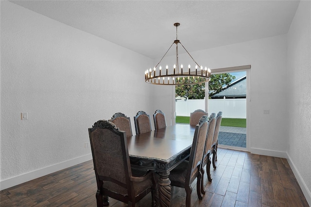 dining area featuring dark hardwood / wood-style floors and an inviting chandelier