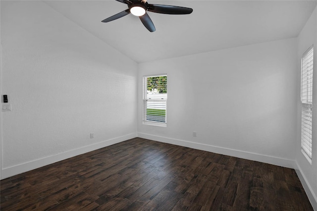 spare room featuring dark hardwood / wood-style flooring, vaulted ceiling, and ceiling fan