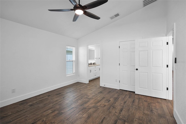 unfurnished bedroom featuring dark hardwood / wood-style flooring, ensuite bath, ceiling fan, and lofted ceiling