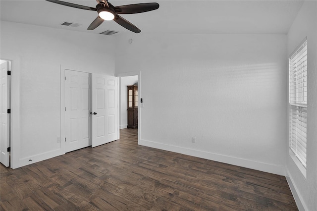 unfurnished bedroom featuring multiple windows, ceiling fan, and dark hardwood / wood-style flooring