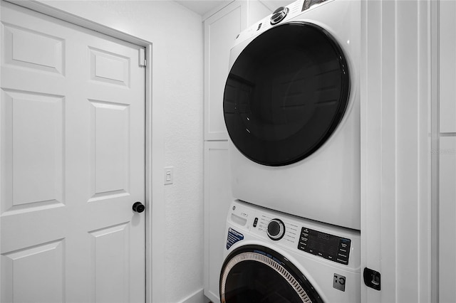 laundry room with stacked washer and dryer