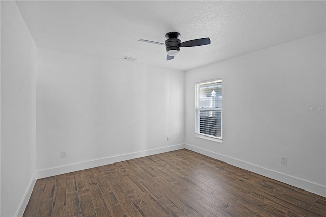 empty room featuring dark hardwood / wood-style flooring and ceiling fan