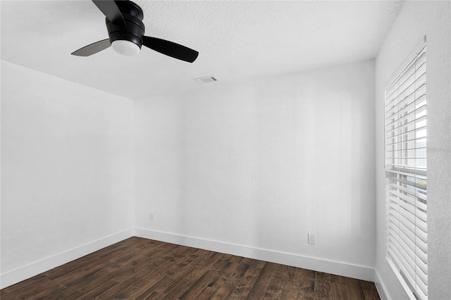 spare room featuring dark hardwood / wood-style floors and ceiling fan