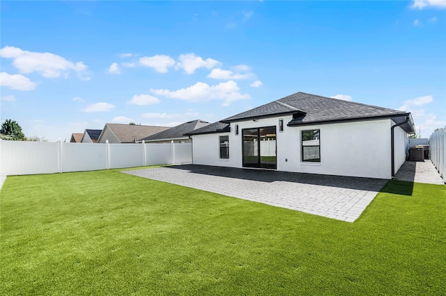 rear view of house with a yard, a patio, and cooling unit