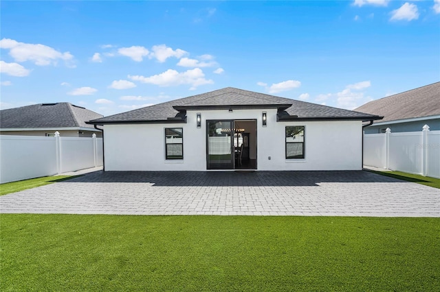 back of house with a yard and a patio