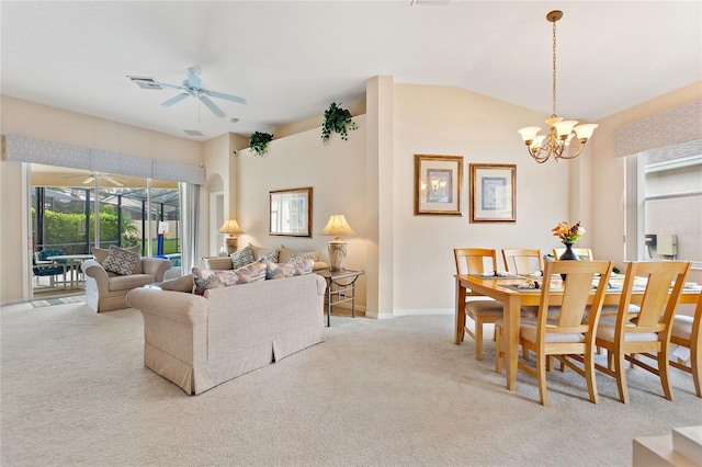 carpeted living room featuring vaulted ceiling and ceiling fan with notable chandelier