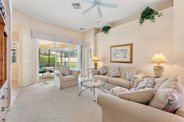 carpeted living room with ceiling fan