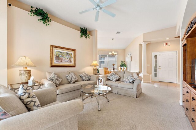 living room with light colored carpet, lofted ceiling, ceiling fan with notable chandelier, and ornate columns