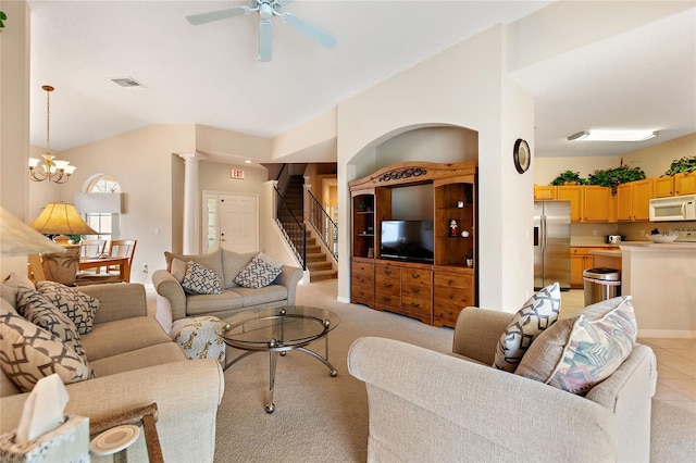 living room featuring ornate columns, vaulted ceiling, light carpet, and ceiling fan with notable chandelier