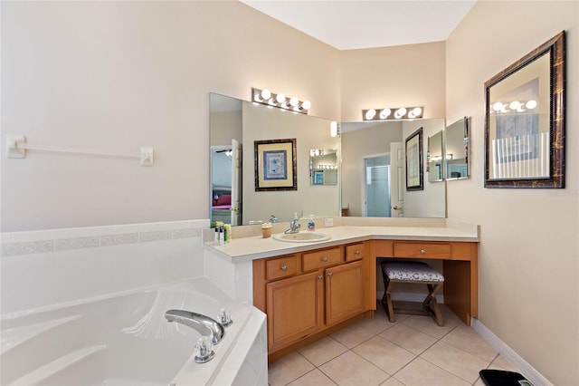 bathroom with tile patterned flooring, tiled tub, and vanity