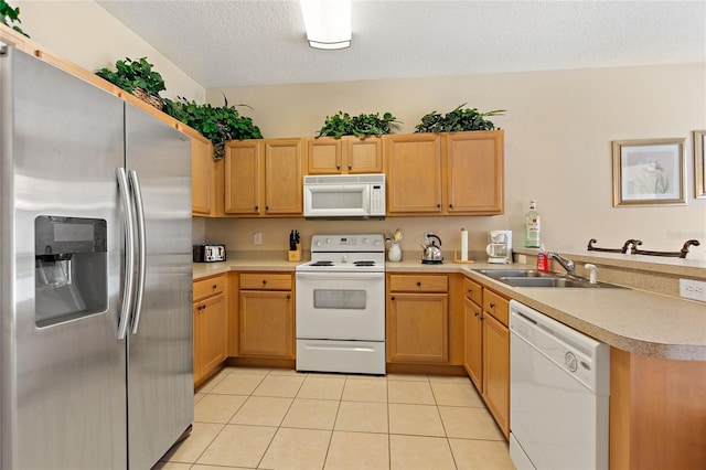 kitchen with sink, a textured ceiling, light tile patterned floors, kitchen peninsula, and white appliances