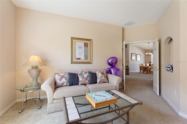 living room with light colored carpet and a chandelier