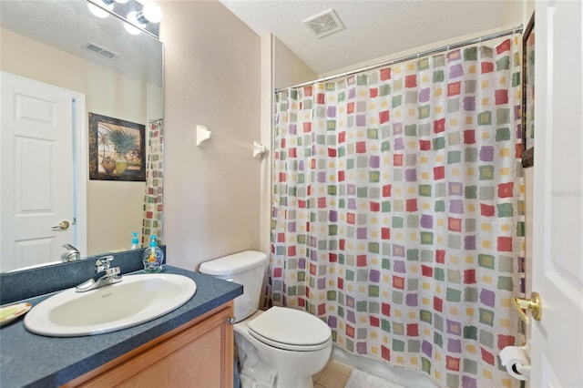 bathroom with vanity, tile patterned flooring, toilet, and a textured ceiling