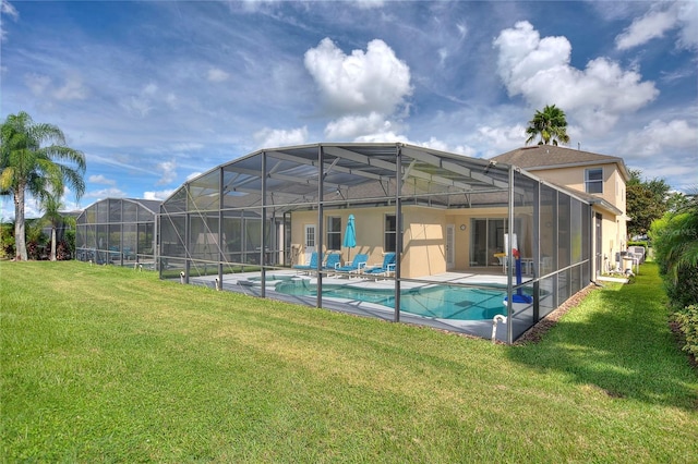 view of swimming pool with a yard, a patio area, and a lanai