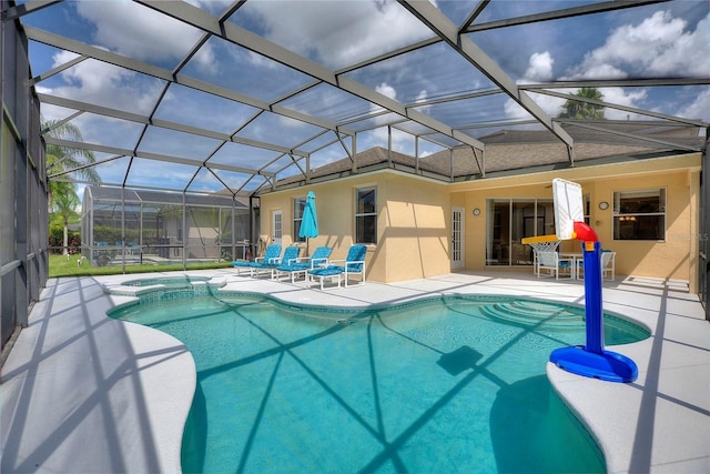 view of pool featuring a patio area and glass enclosure