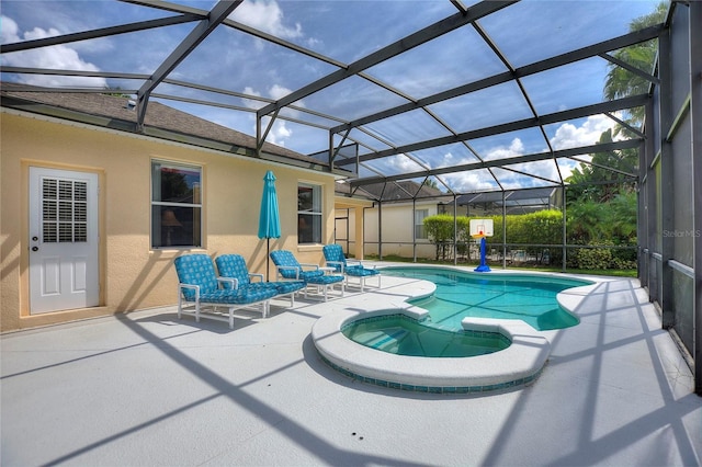 view of swimming pool with a lanai, a patio area, and an in ground hot tub