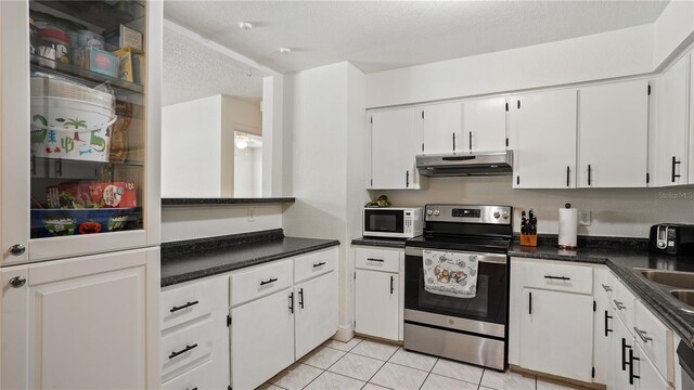 kitchen with a textured ceiling, white cabinets, stainless steel range with electric cooktop, and light tile patterned floors