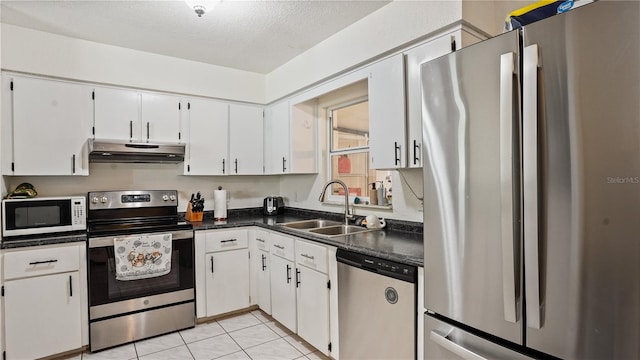 kitchen with sink, appliances with stainless steel finishes, white cabinets, and light tile patterned floors