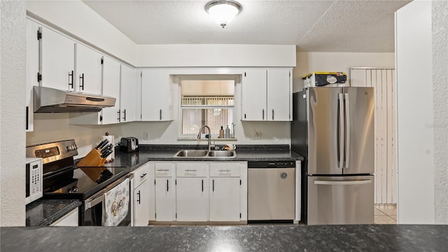 kitchen with white cabinetry, stainless steel appliances, sink, and a textured ceiling