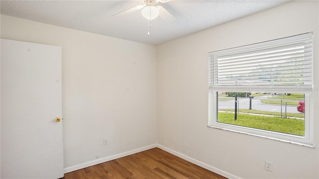 spare room with ceiling fan, a textured ceiling, and hardwood / wood-style flooring