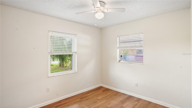 unfurnished room featuring a textured ceiling, ceiling fan, and light wood-type flooring