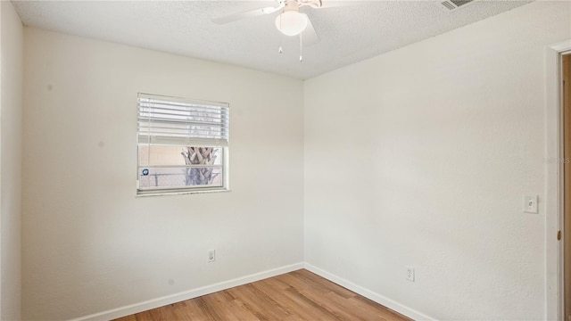 unfurnished room with a textured ceiling, ceiling fan, and hardwood / wood-style floors