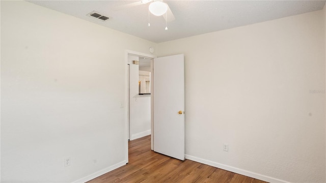 unfurnished room with ceiling fan and hardwood / wood-style floors