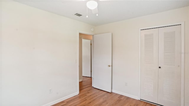 unfurnished bedroom with ceiling fan, light hardwood / wood-style floors, and a closet