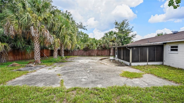 view of yard featuring a patio area and a sunroom