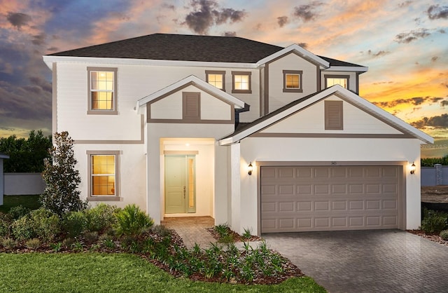 traditional home with driveway and stucco siding