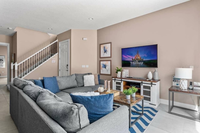 living room featuring a textured ceiling and light tile patterned floors