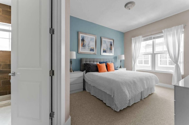 carpeted bedroom featuring multiple windows