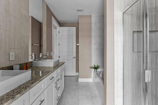 bathroom with plus walk in shower, tile patterned flooring, and dual bowl vanity