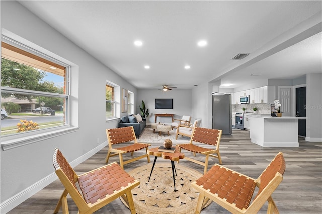 living room with recessed lighting, a ceiling fan, visible vents, baseboards, and light wood finished floors