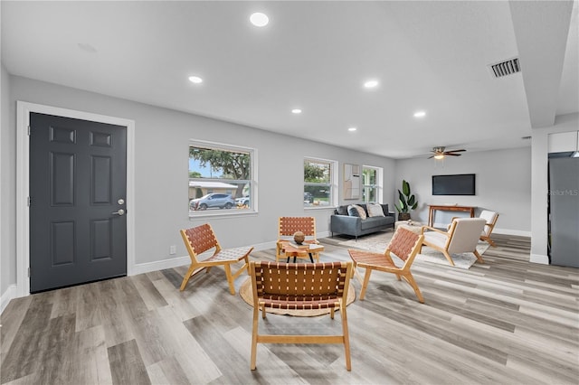 living room featuring visible vents, baseboards, light wood-style flooring, ceiling fan, and recessed lighting