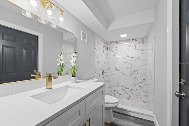 full bathroom featuring toilet, wood finished floors, visible vents, vanity, and a shower stall