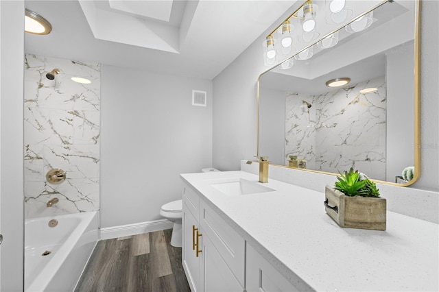 full bath with visible vents, shower / bathing tub combination, toilet, vanity, and wood finished floors