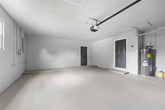 garage featuring concrete block wall, electric water heater, and a garage door opener