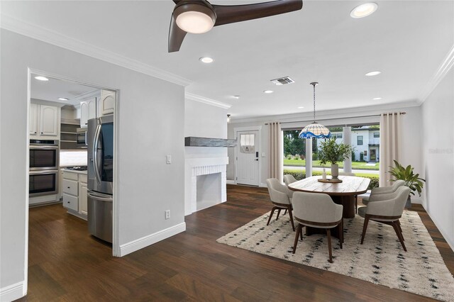 dining space featuring ceiling fan, dark hardwood / wood-style floors, and crown molding