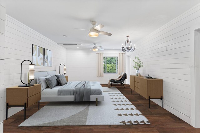 bedroom featuring wood walls, ceiling fan with notable chandelier, and dark hardwood / wood-style flooring