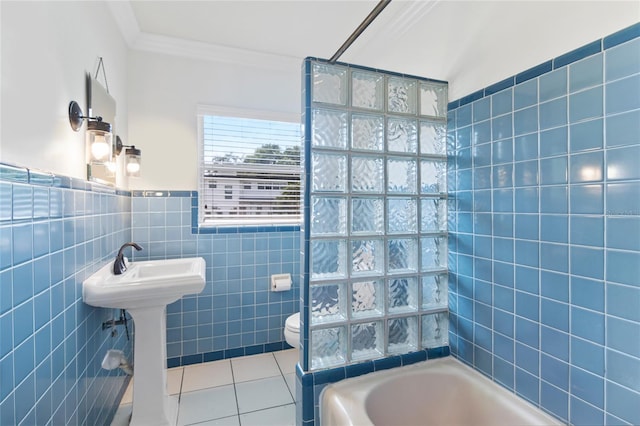 full bathroom featuring tile patterned floors, tile walls, crown molding, sink, and toilet