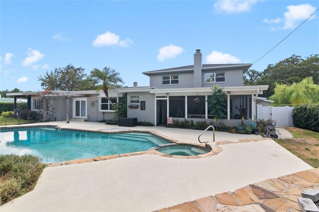 view of pool featuring a patio area and an in ground hot tub