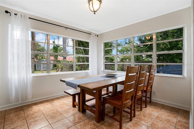 tiled dining area featuring ornamental molding