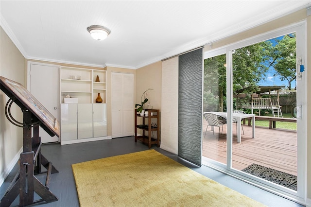 entryway with plenty of natural light and crown molding